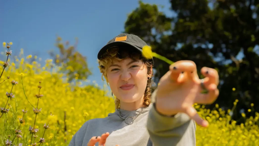 woman holding up daffodil